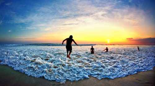 Family playing on the beach during a Costa Rica family vacation