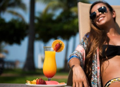 Relaxing at a Costa Rica all-inclusive beach resort with tropical cocktail